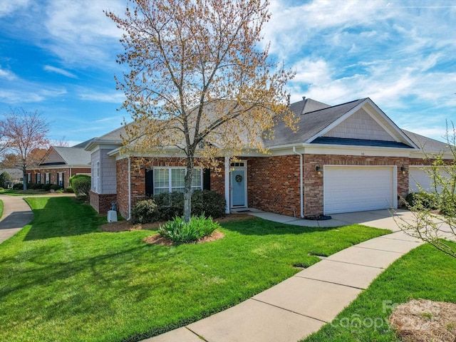 4118 Compostela Ct, Monroe, NC 28110 - view of front of home featuring concrete driveway, roof with shingles, an attached garage, a front yard, and brick siding