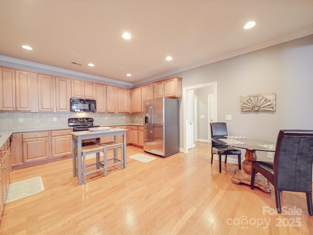 4118 Compostela Ct, Monroe, NC 28110 - kitchen with light wood-type flooring, black appliances, light countertops, and light brown cabinets
