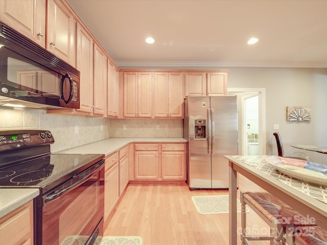 4118 Compostela Ct, Monroe, NC 28110 - kitchen featuring black appliances, light wood-style floors, ornamental molding, and light brown cabinets