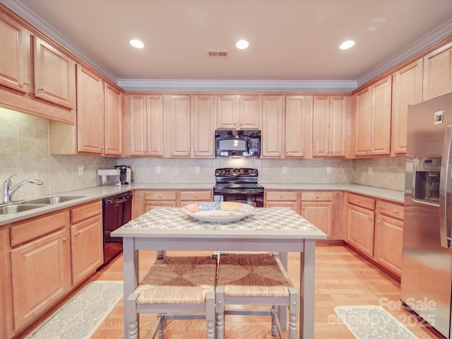 4118 Compostela Ct, Monroe, NC 28110 - kitchen with light countertops, a sink, light brown cabinets, black appliances, and decorative backsplash