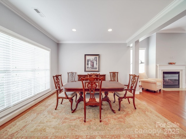 4118 Compostela Ct, Monroe, NC 28110 - dining room with ornamental molding, a fireplace with flush hearth, and wood finished floors