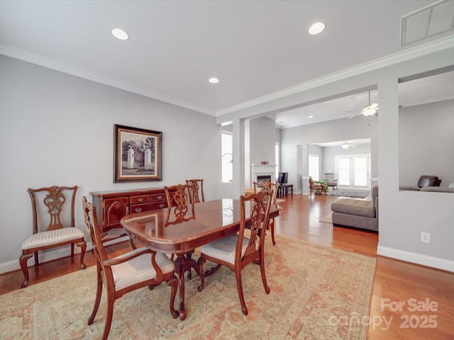 4118 Compostela Ct, Monroe, NC 28110 - dining room featuring light wood-style flooring, visible vents, baseboards, ornamental molding, and a ceiling fan