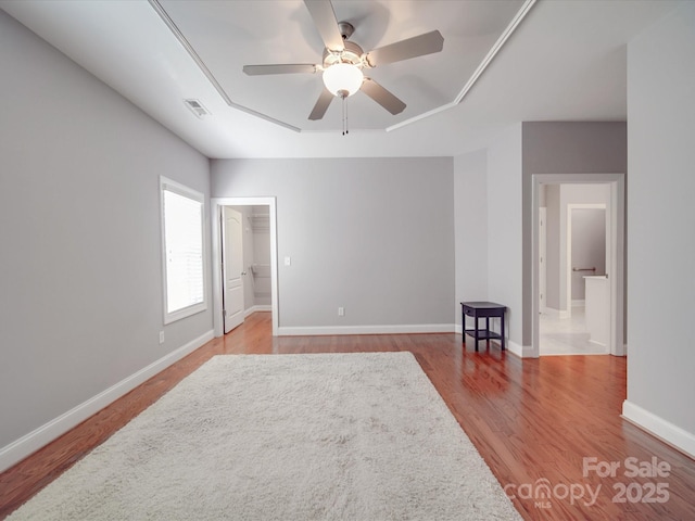 4118 Compostela Ct, Monroe, NC 28110 - empty room featuring visible vents, baseboards, ceiling fan, wood finished floors, and a raised ceiling