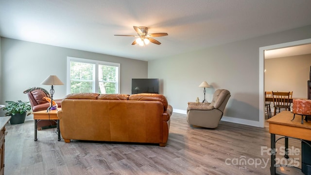 28 Arnie Dr, Etowah, NC 28729 - living room featuring light wood finished floors, baseboards, and ceiling fan