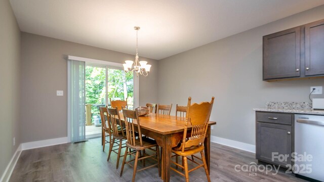 28 Arnie Dr, Etowah, NC 28729 - dining area with a chandelier, dark wood-style floors, and baseboards