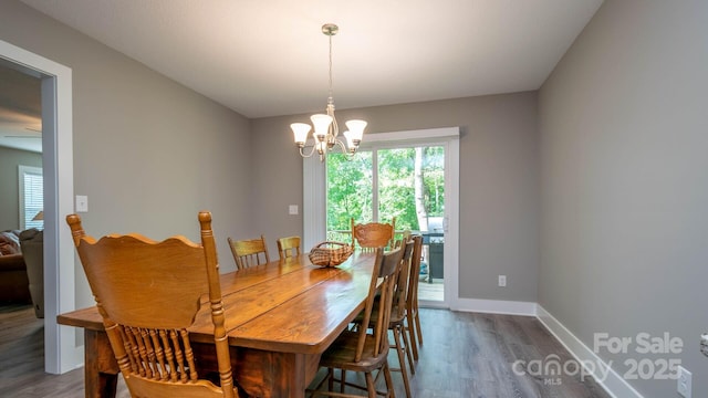 28 Arnie Dr, Etowah, NC 28729 - dining room with a chandelier, baseboards, and wood finished floors