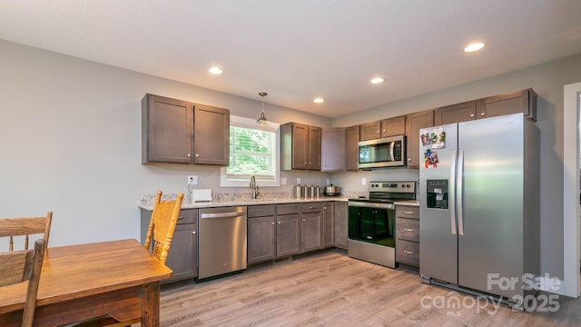 28 Arnie Dr, Etowah, NC 28729 - kitchen featuring light stone counters, light wood-style flooring, recessed lighting, a sink, and stainless steel appliances