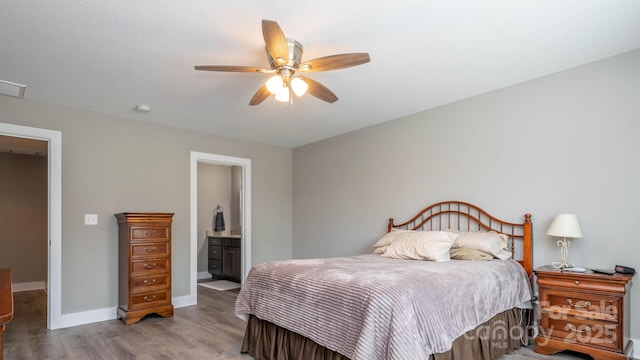 28 Arnie Dr, Etowah, NC 28729 - bedroom with ceiling fan, connected bathroom, baseboards, and wood finished floors