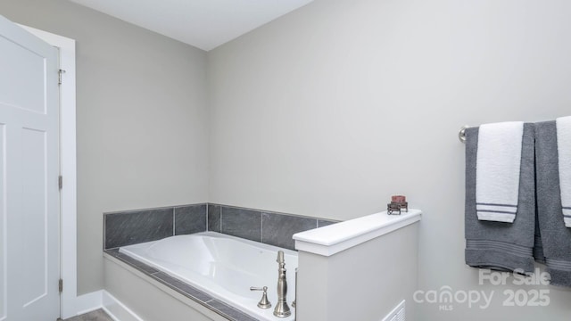 28 Arnie Dr, Etowah, NC 28729 - full bathroom featuring baseboards and a garden tub