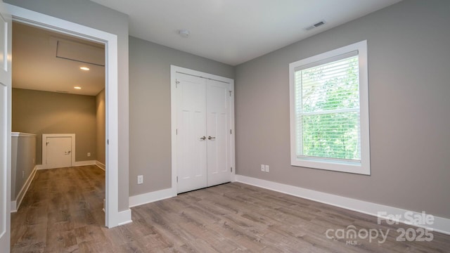 28 Arnie Dr, Etowah, NC 28729 - unfurnished bedroom with a closet, visible vents, baseboards, and wood finished floors