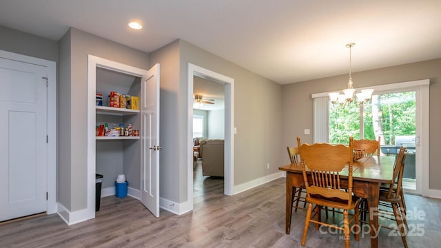 28 Arnie Dr, Etowah, NC 28729 - dining area with wood finished floors, baseboards, and a chandelier
