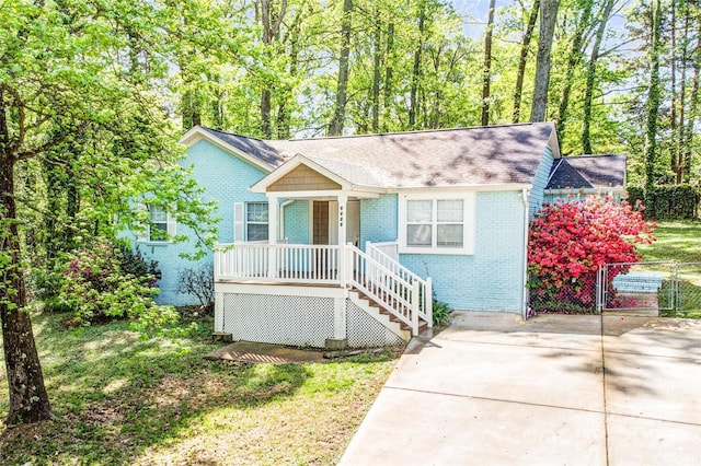 6628 Cool Water Ct, Charlotte, NC 28215 - view of front of home with covered porch, brick siding, fence, stairs, and a shingled roof