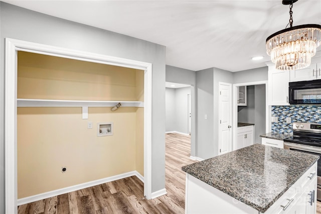 6628 Cool Water Ct, Charlotte, NC 28215 - kitchen featuring stainless steel electric range, black microwave, baseboards, white cabinetry, and light wood-style flooring