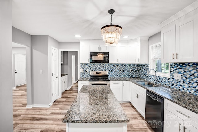 6628 Cool Water Ct, Charlotte, NC 28215 - kitchen featuring a center island, light wood-style flooring, a sink, a notable chandelier, and black appliances