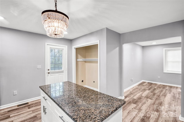 6628 Cool Water Ct, Charlotte, NC 28215 - unfurnished dining area with light wood-style floors, a chandelier, and baseboards