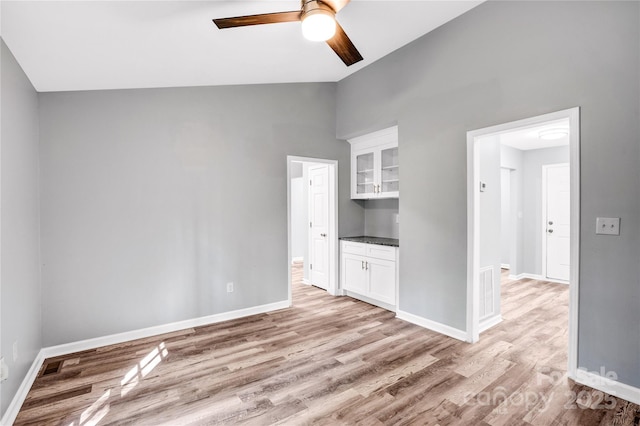 6628 Cool Water Ct, Charlotte, NC 28215 - unfurnished bedroom with light wood-style flooring, baseboards, high vaulted ceiling, and a ceiling fan