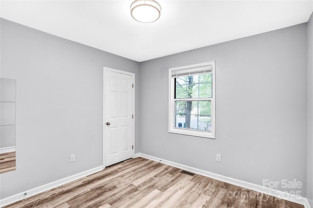 6628 Cool Water Ct, Charlotte, NC 28215 - empty room with light wood-style floors and baseboards