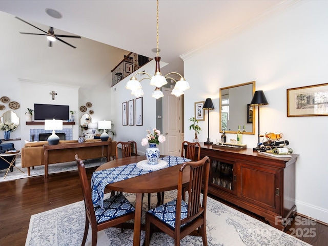 6301 Park Dr S, Charlotte, NC 28210 - dining area with wood finished floors, ceiling fan, a fireplace, ornamental molding, and baseboards