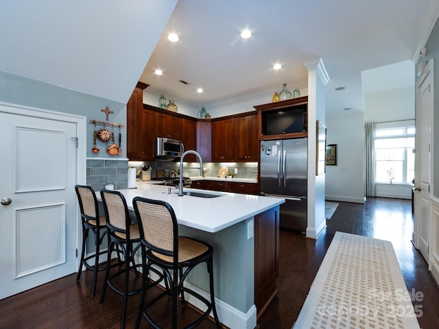 6301 Park Dr S, Charlotte, NC 28210 - kitchen featuring appliances with stainless steel finishes, a sink, a peninsula, light countertops, and decorative backsplash