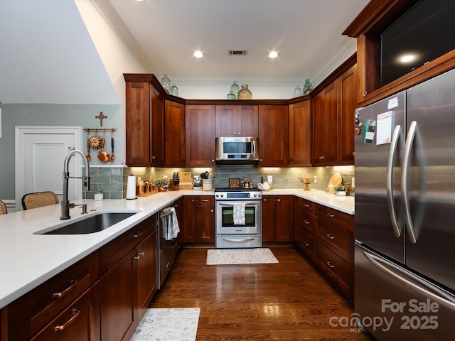 6301 Park Dr S, Charlotte, NC 28210 - kitchen featuring stainless steel appliances, a sink, light countertops, tasteful backsplash, and crown molding