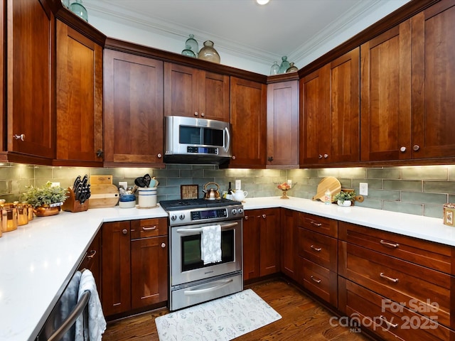 6301 Park Dr S, Charlotte, NC 28210 - kitchen featuring appliances with stainless steel finishes, ornamental molding, dark wood-style floors, light countertops, and backsplash