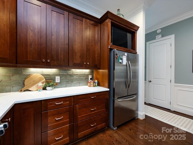 6301 Park Dr S, Charlotte, NC 28210 - kitchen with freestanding refrigerator, ornamental molding, dark wood-type flooring, backsplash, and light countertops