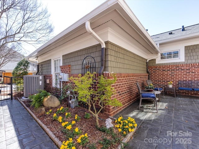 6301 Park Dr S, Charlotte, NC 28210 - view of side of home with brick siding, a patio, and cooling unit