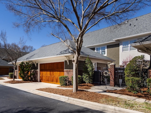 6301 Park Dr S, Charlotte, NC 28210 - view of front of property featuring driveway, roof with shingles, an attached garage, and brick siding
