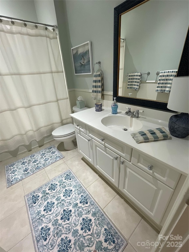 6301 Park Dr S, Charlotte, NC 28210 - full bathroom with vanity, tile patterned flooring, toilet, a shower with curtain, and wainscoting