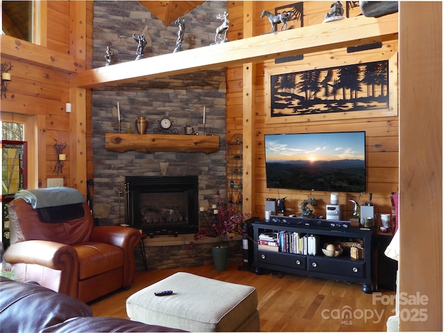 133 Saratoga Dr, Bostic, NC 28018 - living room featuring a stone fireplace, wooden walls, wood finished floors, and a towering ceiling