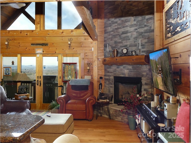 133 Saratoga Dr, Bostic, NC 28018 - living area featuring wood finished floors, a fireplace, wood walls, and high vaulted ceiling
