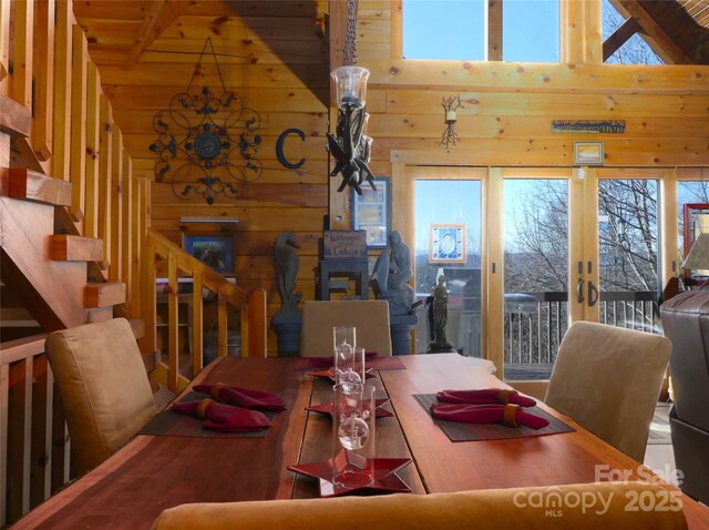 133 Saratoga Dr, Bostic, NC 28018 - dining room featuring stairway, a healthy amount of sunlight, high vaulted ceiling, and wood walls