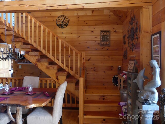 133 Saratoga Dr, Bostic, NC 28018 - dining space featuring wood walls, an inviting chandelier, and wood finished floors