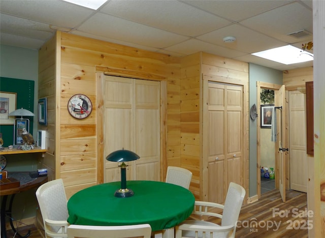 133 Saratoga Dr, Bostic, NC 28018 - dining space featuring wood finished floors, visible vents, a paneled ceiling, and wood walls