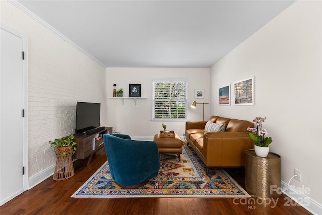 living area featuring baseboards and wood finished floors