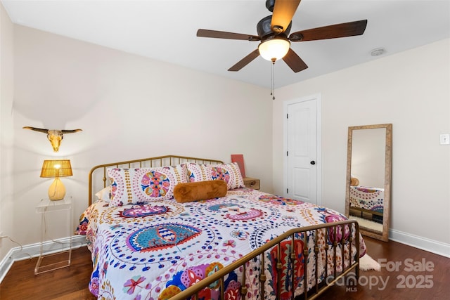 bedroom with wood finished floors, baseboards, and ceiling fan
