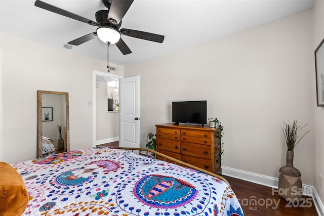 bedroom with baseboards, wood finished floors, and a ceiling fan