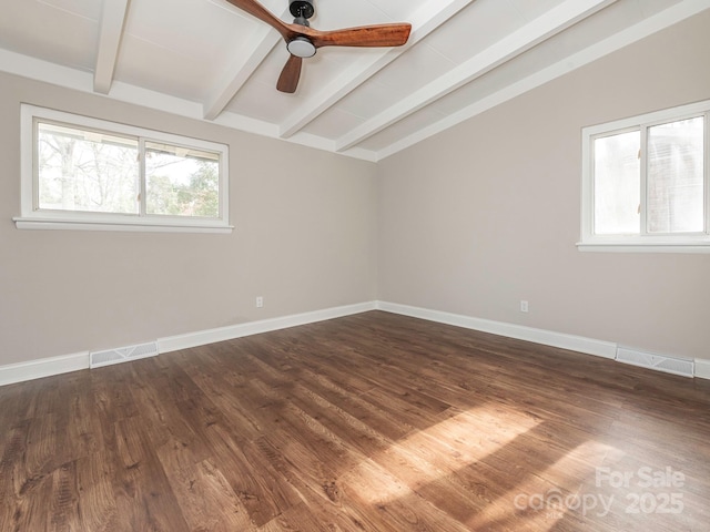empty room featuring vaulted ceiling with beams, baseboards, dark wood-type flooring, and visible vents