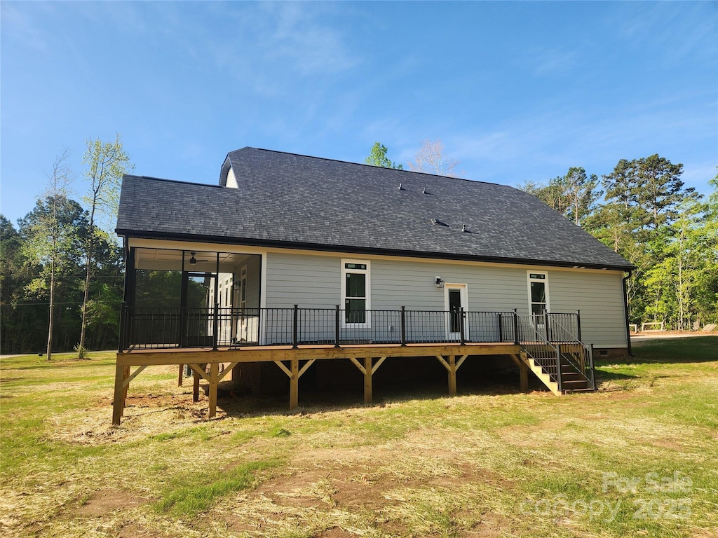 back of property featuring a lawn, crawl space, a wooden deck, and stairs