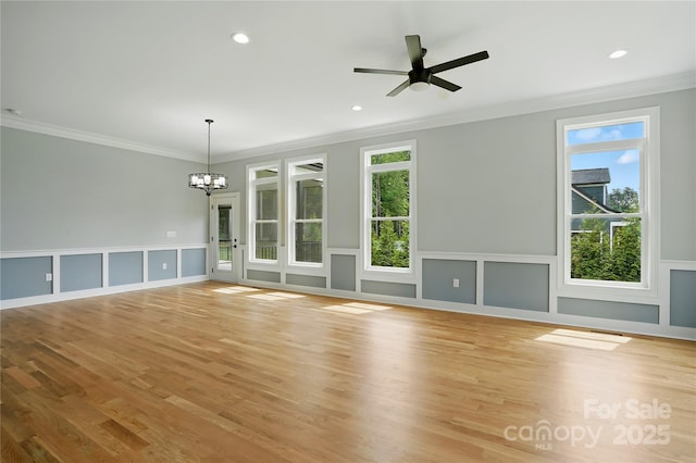 409 Henry Chapel Rd, Belmont, NC 28012 - unfurnished living room featuring crown molding, a chandelier, light wood-style flooring, a decorative wall, and a ceiling fan