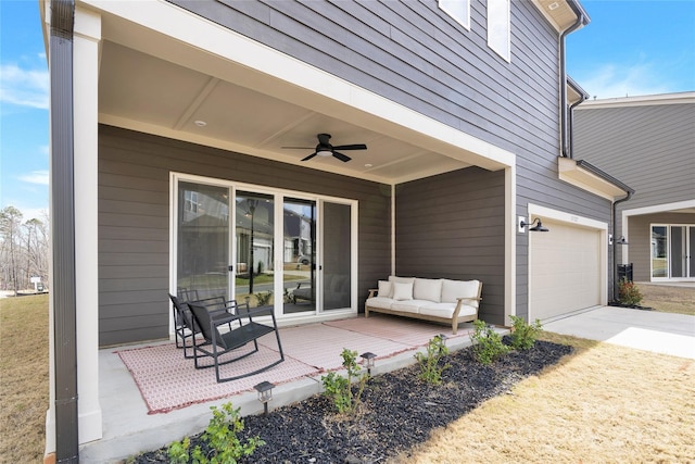view of patio with concrete driveway, ceiling fan, and an attached garage