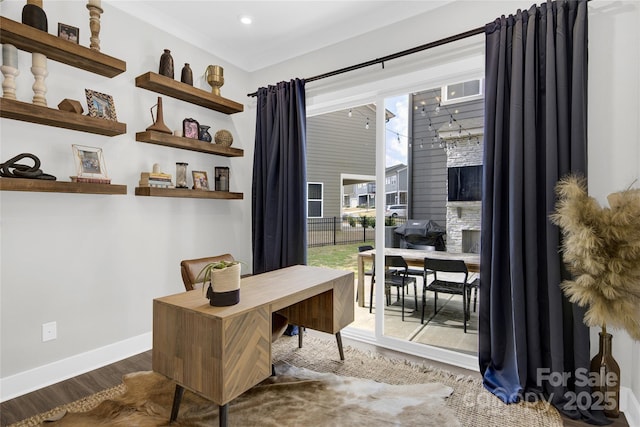 office area featuring baseboards and wood finished floors