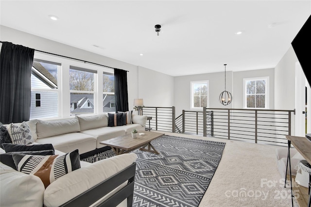 living room featuring carpet, recessed lighting, and a chandelier