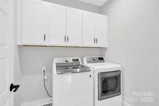 washroom with cabinet space and separate washer and dryer