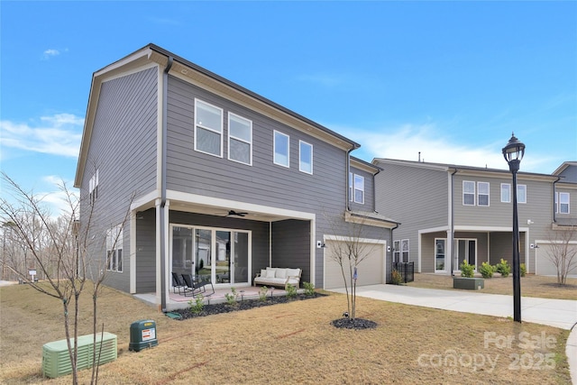 view of front of property with an outdoor living space, a garage, driveway, and a patio