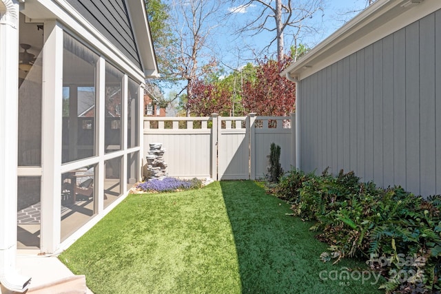 view of yard with a sunroom and fence