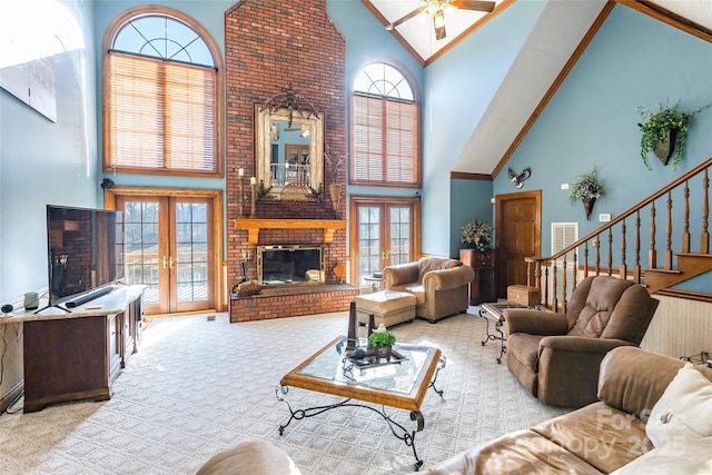 living room with french doors, carpet floors, a high ceiling, and a ceiling fan