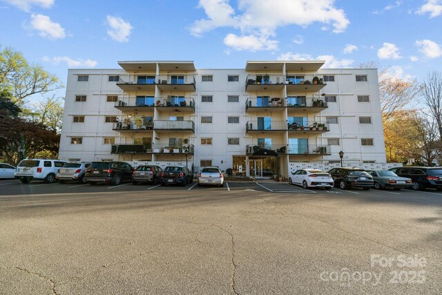 view of property featuring uncovered parking