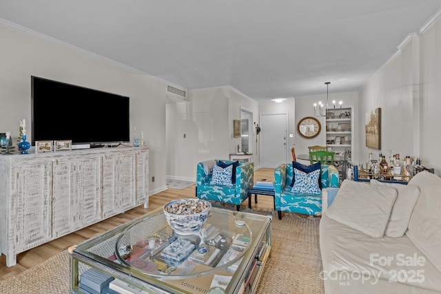 2503 Roswell Ave Unit 208, Charlotte, NC 28209 - living room featuring a chandelier, wood finished floors, and ornamental molding