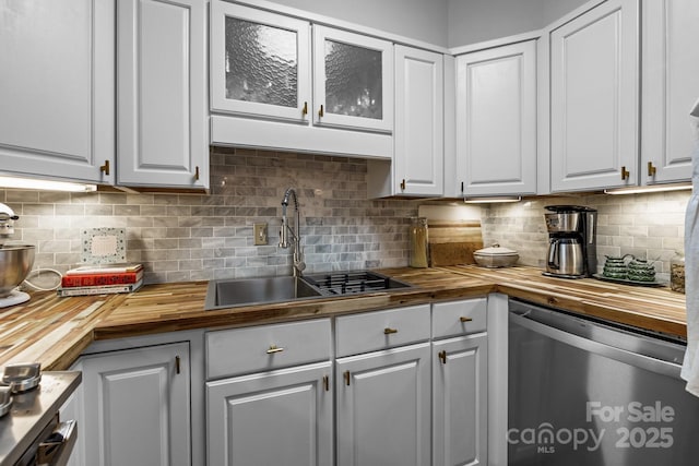 2503 Roswell Ave Unit 208, Charlotte, NC 28209 - kitchen with butcher block countertops, stainless steel dishwasher, white cabinets, and backsplash